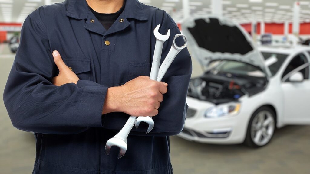 service technician having wrench in hand